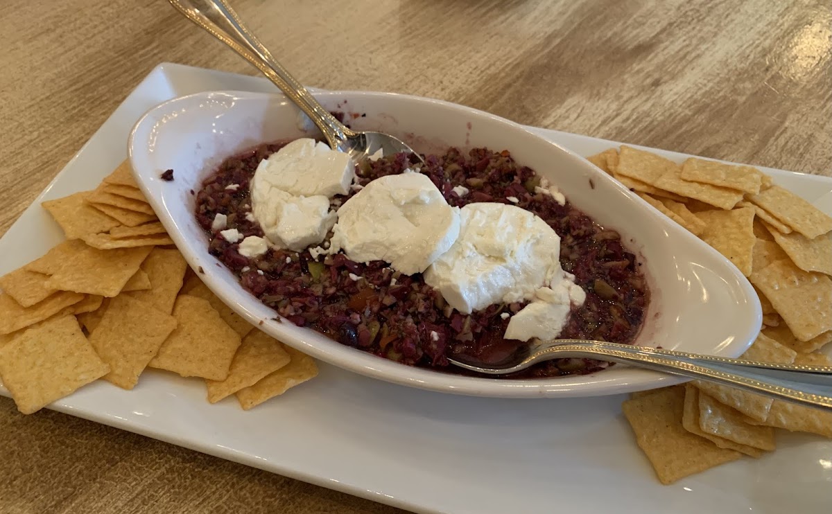 Olive Tepenade with goat cheese served with delicious rice crackers