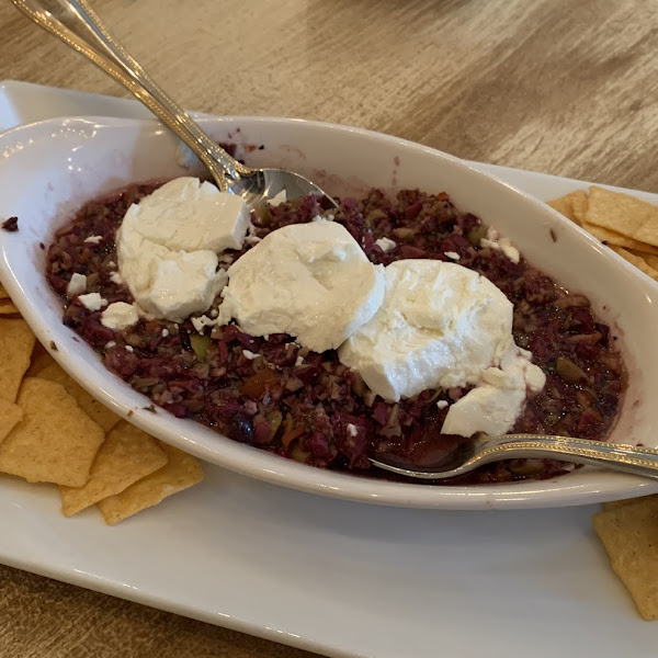 Olive Tepenade with goat cheese served with delicious rice crackers