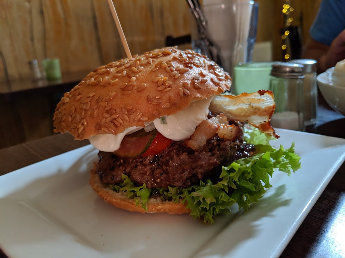 Burger w bacon (mostly fatty), topped with sour cream and BBQ sauce (on GF bun, of course)