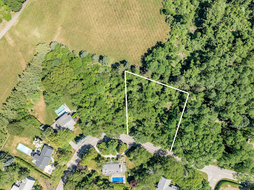 Aerial view of wooded lot with boundary outline in this luxury house for sale in Shelter Island ($575,000)