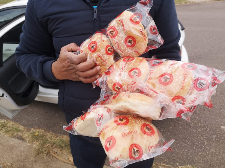 A Durban resident stocks up on bread rolls.