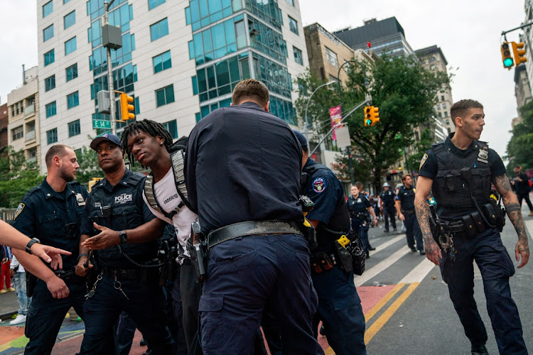 Police officers detain a person after popular live streamer Kai Cenat announced a "giveaway" event that grew chaotic, prompting police officers to respond and disperse the crowd at Union Square and the surrounding streets, in New York City, US August 4, 2023.