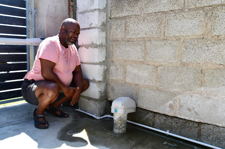 NOT FIXED: Vuyo Boyana looks at the water leak he has reported to the municipality