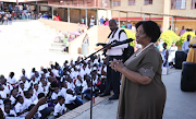 Basic education minister Angie Motshekga addresses parents and pupils on the first day of the school year on January 11 at Cosmo City Primary School in Johannesburg.