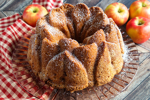 Layered Fresh Apple Cake dusted with powdered sugar.