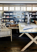 The dark paint detail of the wall of shelves helps pull this office look together, creating a sense of intimacy and calm.