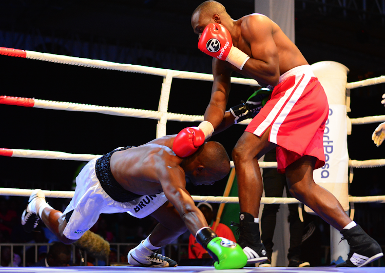 Rayton Okwiri (R) puts Bruno Kimani to the canvas in their undercard bout during the SportPesa Nairobi Fight Night over the weekend