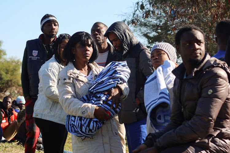 Ivory Coast nationals living in Tunisia and seeking repatriation, wait outside the embassy of Ivory Coast in Tunis, Tunisia.