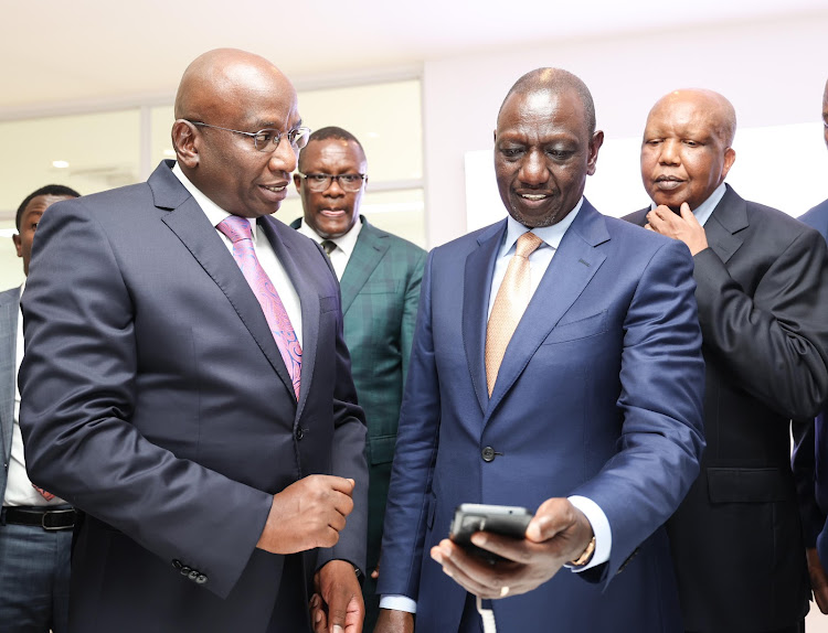 President William Ruto samples one of the phones at East Africa Device Assembly Kenya factory in Athi River, Machakos on October 30, 2023.