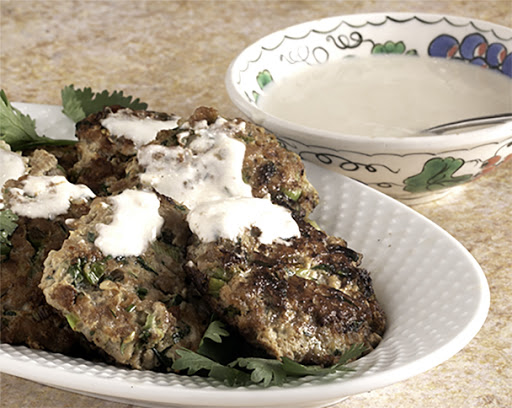 Grated zucchini added to the minced turkey moistens them. Smothered with an even lighter tahini yoghurt sauce and you have a great mid week summer dinner.