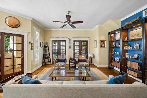 Living room with fireplace and wall bookshelf in this luxury house for sale in Houston ($1,180,000)