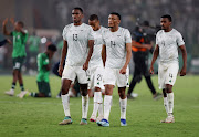 Bafana Bafana's Mothobi Mvala, centre, Sphephelo Sithole, left, and Teboho Mokoena, right, look dejected after being eliminated from the Africa Cup of Nations in their penalties semifinal defeat against Nigeria at Stade de la Paix in Bouake, Ivory Coast on Wednesday night.