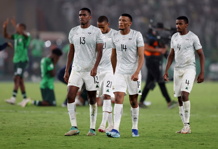 Bafana Bafana's Mothobi Mvala, centre, Sphephelo Sithole, left, and Teboho Mokoena, right, look dejected after being eliminated from the Africa Cup of Nations in their penalties semifinal defeat against Nigeria at Stade de la Paix in Bouake, Ivory Coast on Wednesday night.