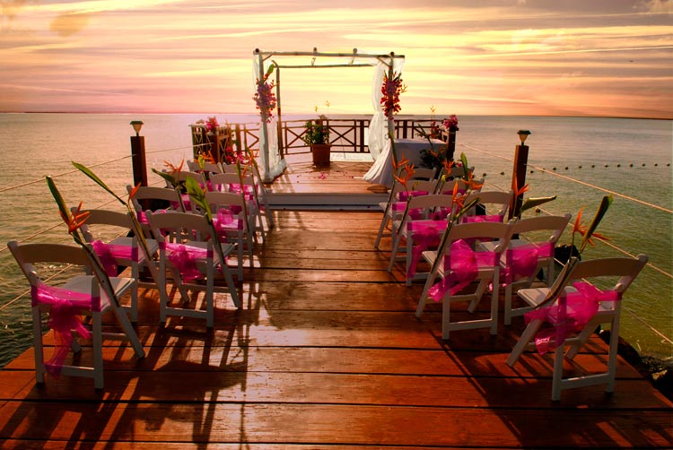 A sunset paints the sky just after a boardwalk wedding at Calabash Cove.