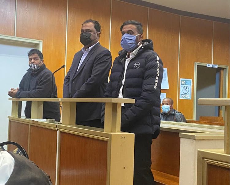 Eastern Cape chief director of community safety and liaison, Neil Naidoo, left, and businessmen Kenny Govender, middle, and Matthew Pillay in the East London magistrate's court on Monday.