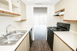 View of living room from kitchen with wood inspired floors