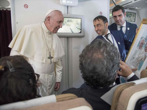 Pope Francis receives a gift from a journalist during a questions session after his visit to Abu Dhabi, United Arab Emirates, February 5, 2019. /REUTERS