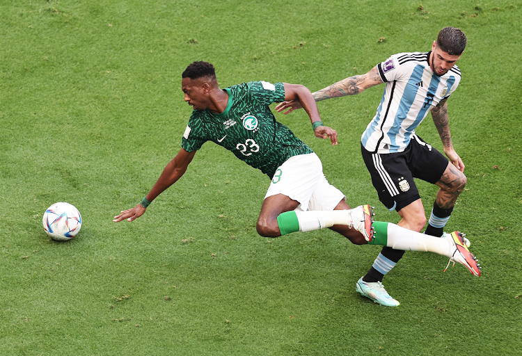 Mohamed Kanno of Saudi Arabia vies for the ball with Rodrigo de Paul of Argentina