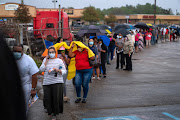 People line up to cast their ballot for the upcoming presidential election as early voting ends and as tropical storm Zeta approaches the Gulf Coast in New Orleans, Louisiana, U.S., October 27, 2020. 