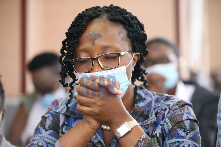 A Faithful offer her prayers at a service lead by Cardinal John Njue of the Holy Family Basilica Church in Nairobi during the Ash Wednesday prayers on February 17, 2021.