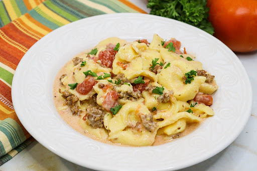 A bowl of Crock Pot Cheese Tortellini and Sausage.