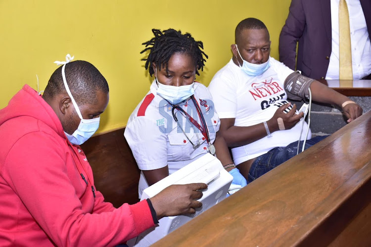 AAR nurse Jackline Chepkoech attends to former Nairobi Governor Mike Sonko at Kiambu law court on February 9.