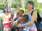 The woman charged with child abuse posted this photograph on Facebook of herself with children when they visited a crocodile farm.