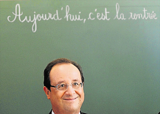 French President Francois Hollande either smiling or clowning - reports differ - at a primary school in Denain, northern France