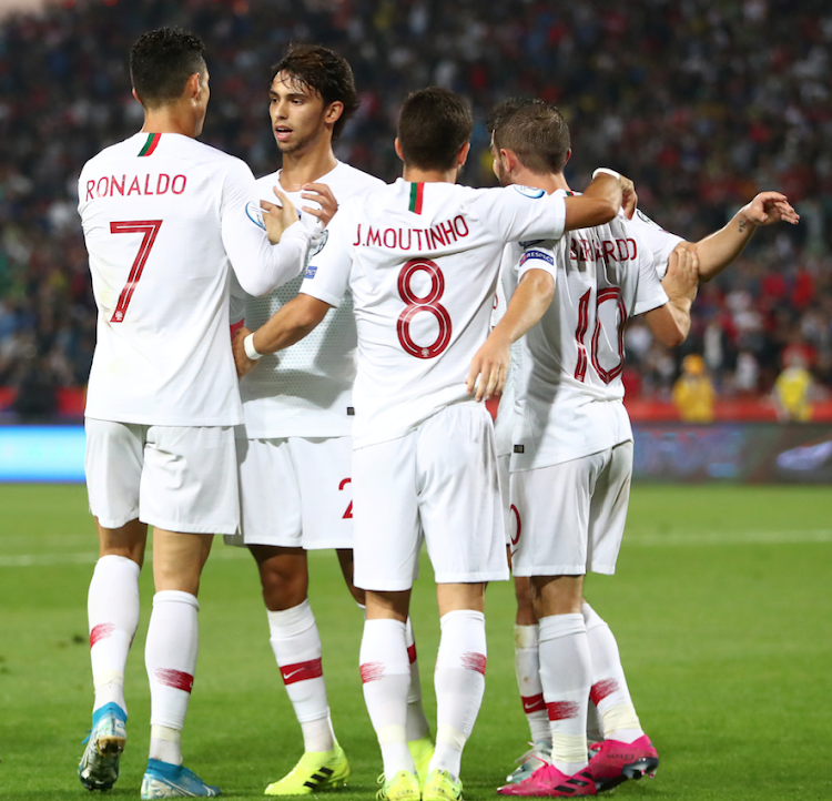 Portugal's Cristiano Ronaldo, Joao Moutinho and team mates celebrate at the end of the match