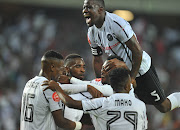 Substitute Tshegofatso Mabasa celebrates with teammates after scoring.  