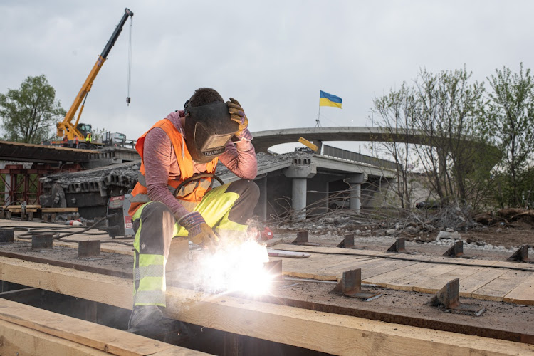 A worker on a construction site of a new bridge in Stoyanka, Ukraine, on May 7 2022. Following Russia's retreat from areas around the Ukrainian capital, signs of normal life have returned to Kyiv, with residents taking advantage of shortened curfew hours, businesses reopening and foreign countries promising to return their diplomats.