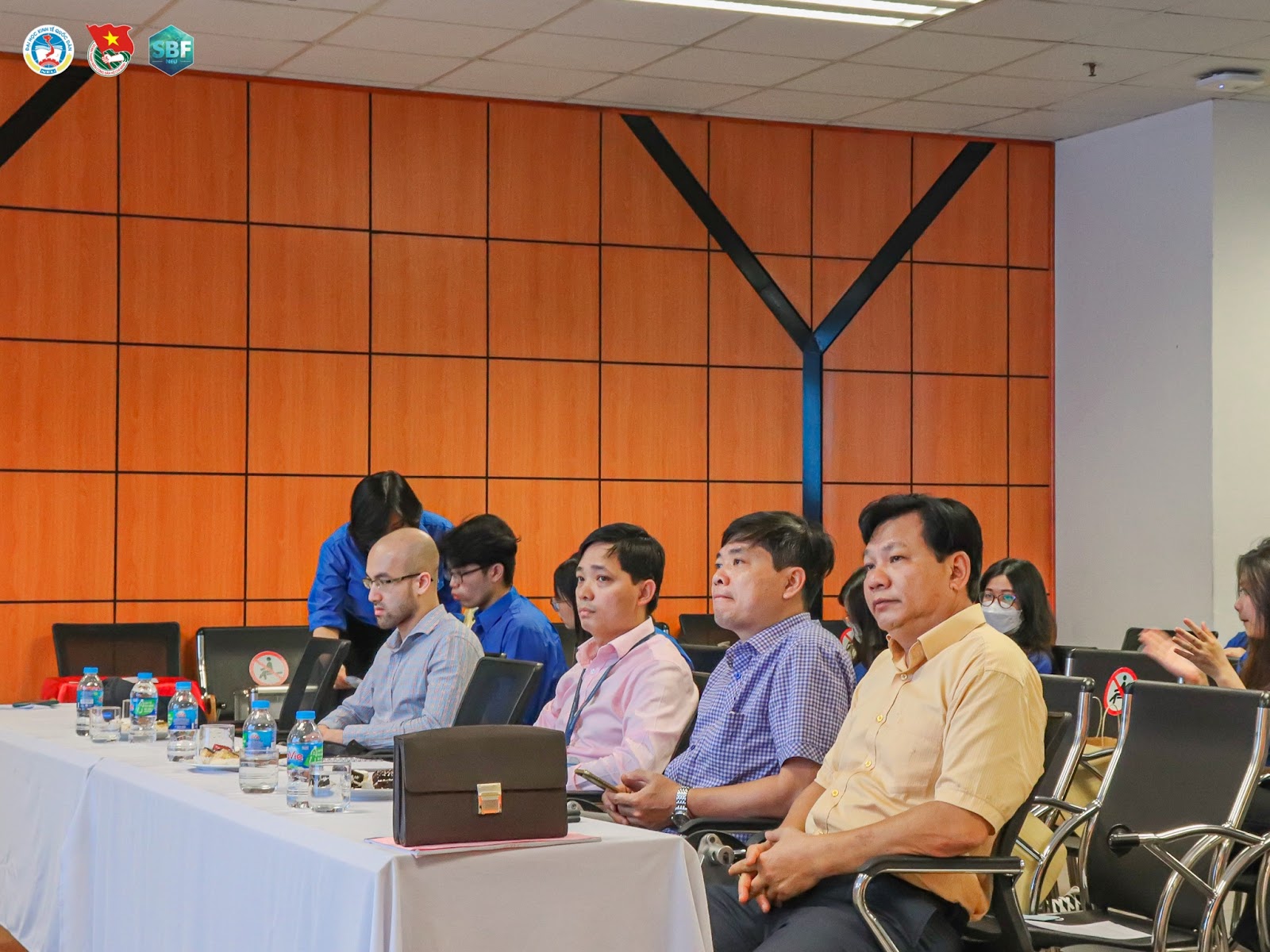 May be an image of 5 people, people sitting, people standing and indoor