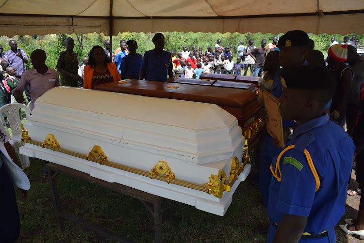 Homa Bay county askaris near caskets of four people who died from ravaging floods on a vehicle to ferry for burial in Sindo, Suba South constituency on May 15,2024
