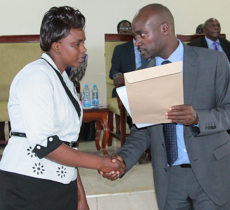 Bomet Governor Hillary Barchok presents a confirmation letter one of the Early Childhood Development Education (ECDE) teachers at the county headquarters on Wednesday, February 19, 2020