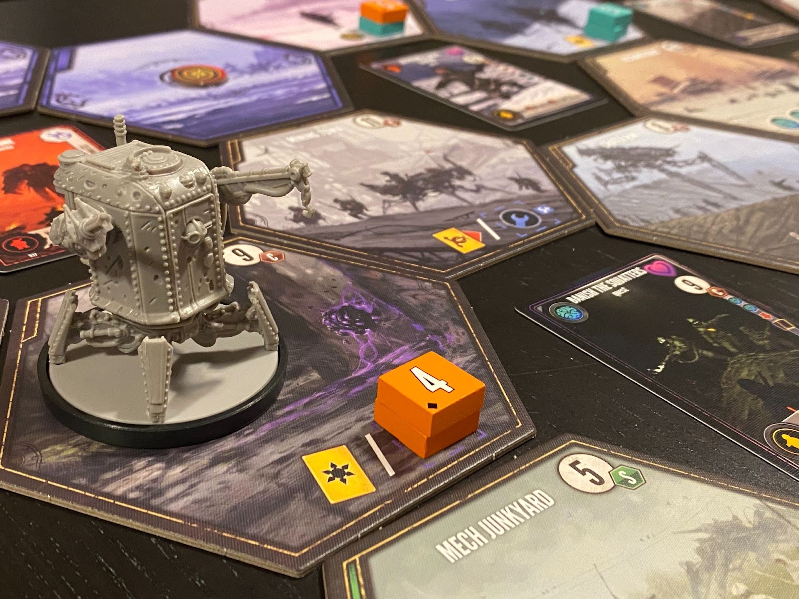 A picture of the game Expeditions, with a plastic mech placed amid hexagonal tiles picturing alternative history eastern Europe.