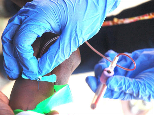 Public health officers collect blood sample./FILE