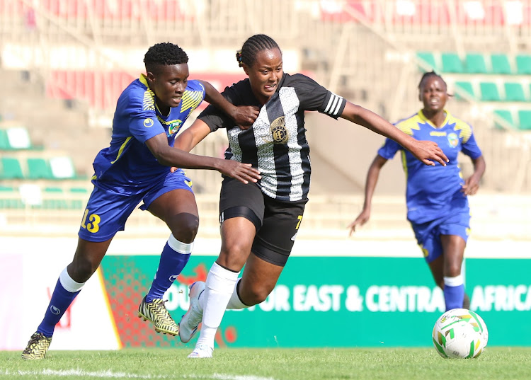 Vihiga queens' Vivian Makokha (L) contests for the ball with Loza Abera from Commercial Bank of Ethiopia during the Cecafa Champions League qualifiers at Nyayo Stadium.