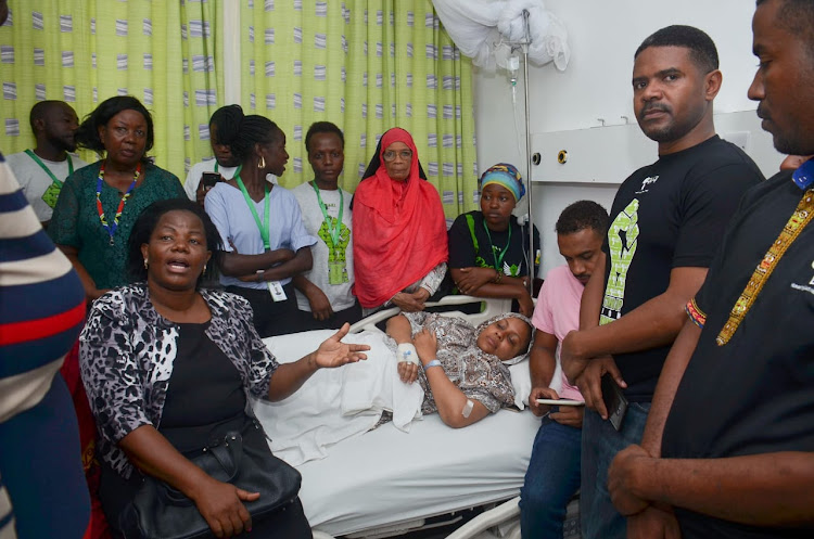 Human rights activists at Salma Hemed's hospital bed on Wednesday.