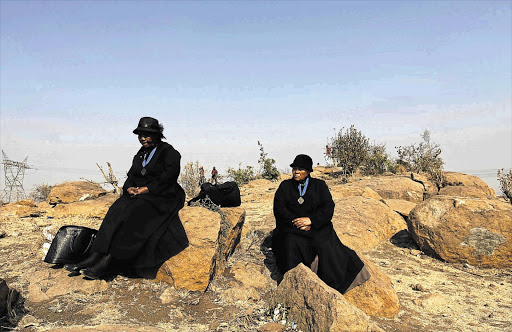 Members of a local church mourn on a hill near a site where 34 miners were killed during clashes at Lonmin's Marikana platinum mine ahead of a memorial service in Rustenburg. File photo