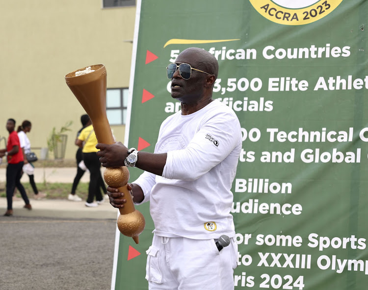 Reks Brobby, Deputy Chief Operating Officer of the Local Organising Committee for the 13th African Games, displays the torch at the unveiling ceremony held in Accra, Ghana, on Feb 14