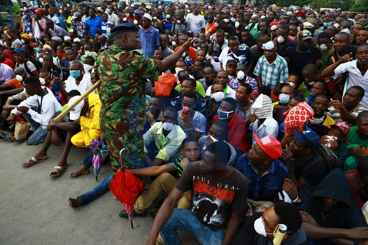 Mombasa residents bundled up amid the curfew coming into effect on Friday, March 27, 2020.