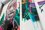 Belgian-Congolese street artist NovaDead, whose real name is Julien Crevaels, paints a giant mural paying tribute to George Floyd in Brussels, Belgium, on June 1. 