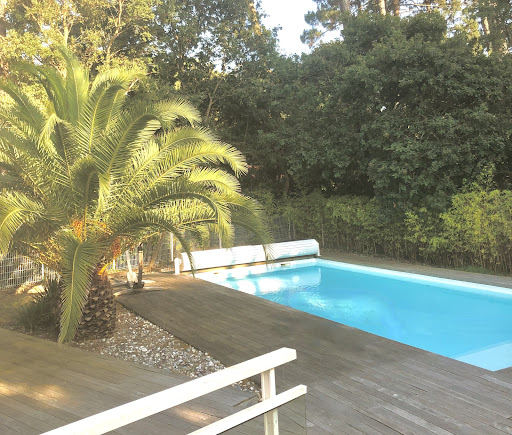 Outdoor swimming pool with wooden terrace - Buy this luxury property in Seignosse, 7 rooms, 5 bedrooms