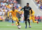 Kaizer Chiefs midfielder Pule Ekstein (L) challenges Orlando Pirates defender and captain Happy Jele (R) during the 1-1 Absa Premiership Soweto derby draw at FNB Stadium on February 9 2019.  