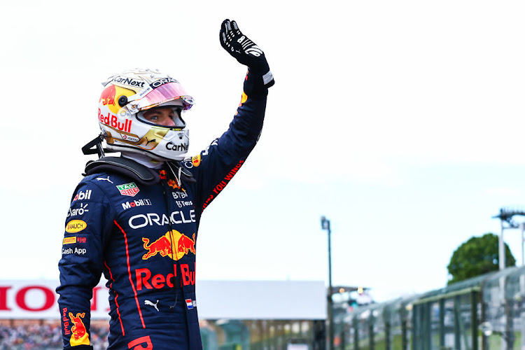 Pole position qualifier Max Verstappen celebrates in parc ferme during qualifying ahead of the F1 Grand Prix of Japan at Suzuka International Racing Course on October 08, 2022 in Suzuka, Japan.