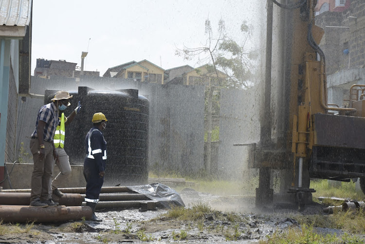 Ruiru MP Simon King'ara (in hat) oversees drilling of a borehole at Kahawa Wendani Primary School on Saturday, July 25, 2020.