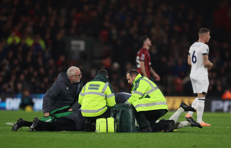 Luton Town's Tom Lockyer receives medical attention.