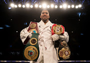 Anthony Joshua poses with his belts after his WBA, IBF, WBO & IBO Heavyweight Championship title fight at Joseph Parker Principality Stadium on March 31, 2018 in Cardiff, Wales.