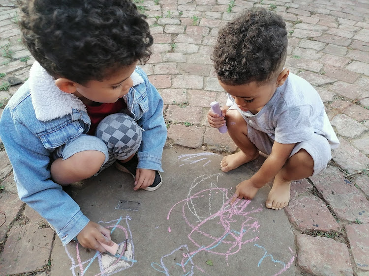 CHALK IT UP: Eleanor Douglas-Meyers’ son Aidan and his cousin Liam during play time