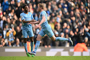 Kevin De Bruyne celebrates with teammate Raheem Sterling of Manchester City after scoring their team's first goal in the Premier League match against Chelsea at Etihad Stadium in Manchester on January 15 2022.